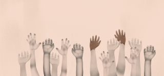 group of multi racial children's hands up 