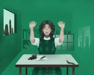 girl at school classroom with hands up as she spill the ink on the desk