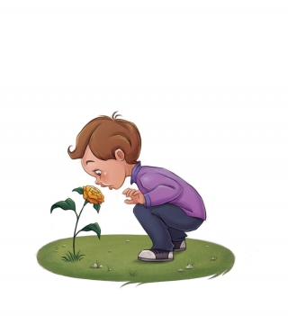 A little boy smelling a flower