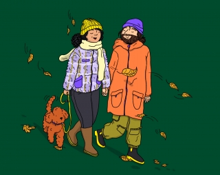 A couple and their dog are taking a walk in autumn.